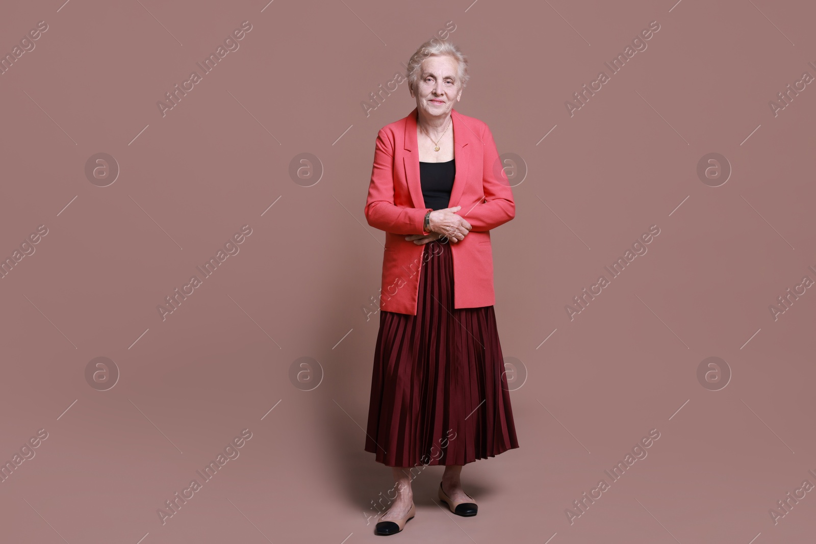 Photo of Full length portrait of senior woman on color background