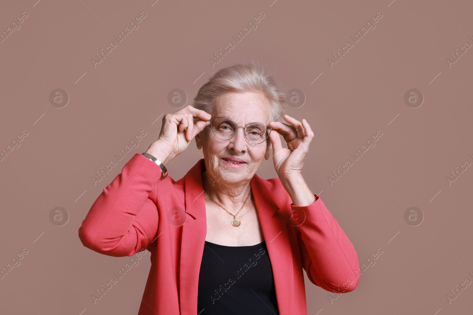 Photo of Portrait of senior woman on color background