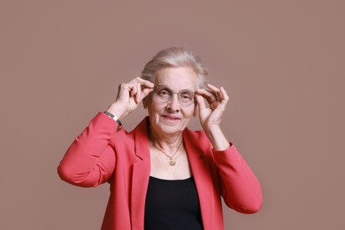 Photo of Portrait of senior woman on color background