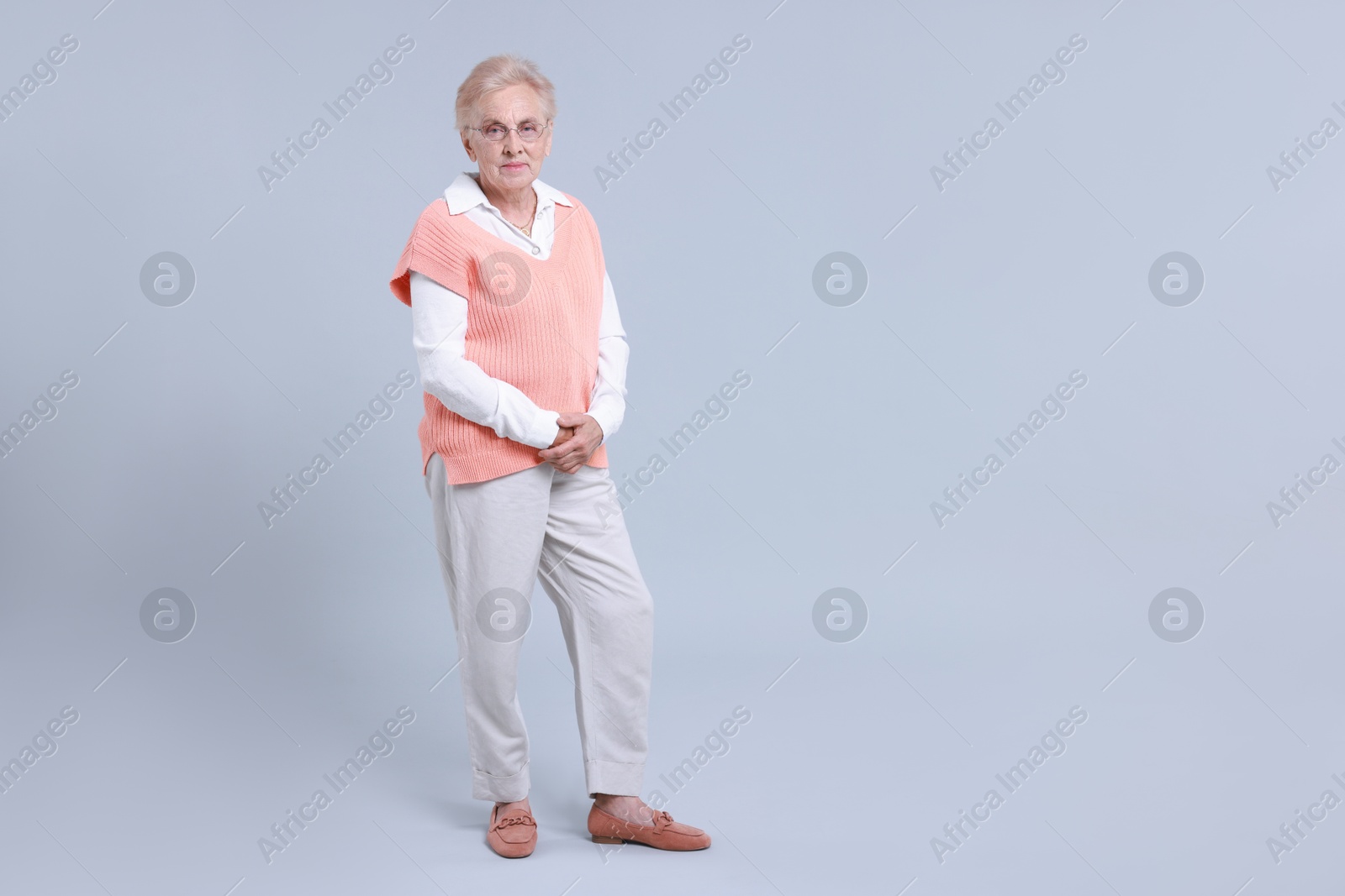 Photo of Full length portrait of senior woman on light background. Space for text