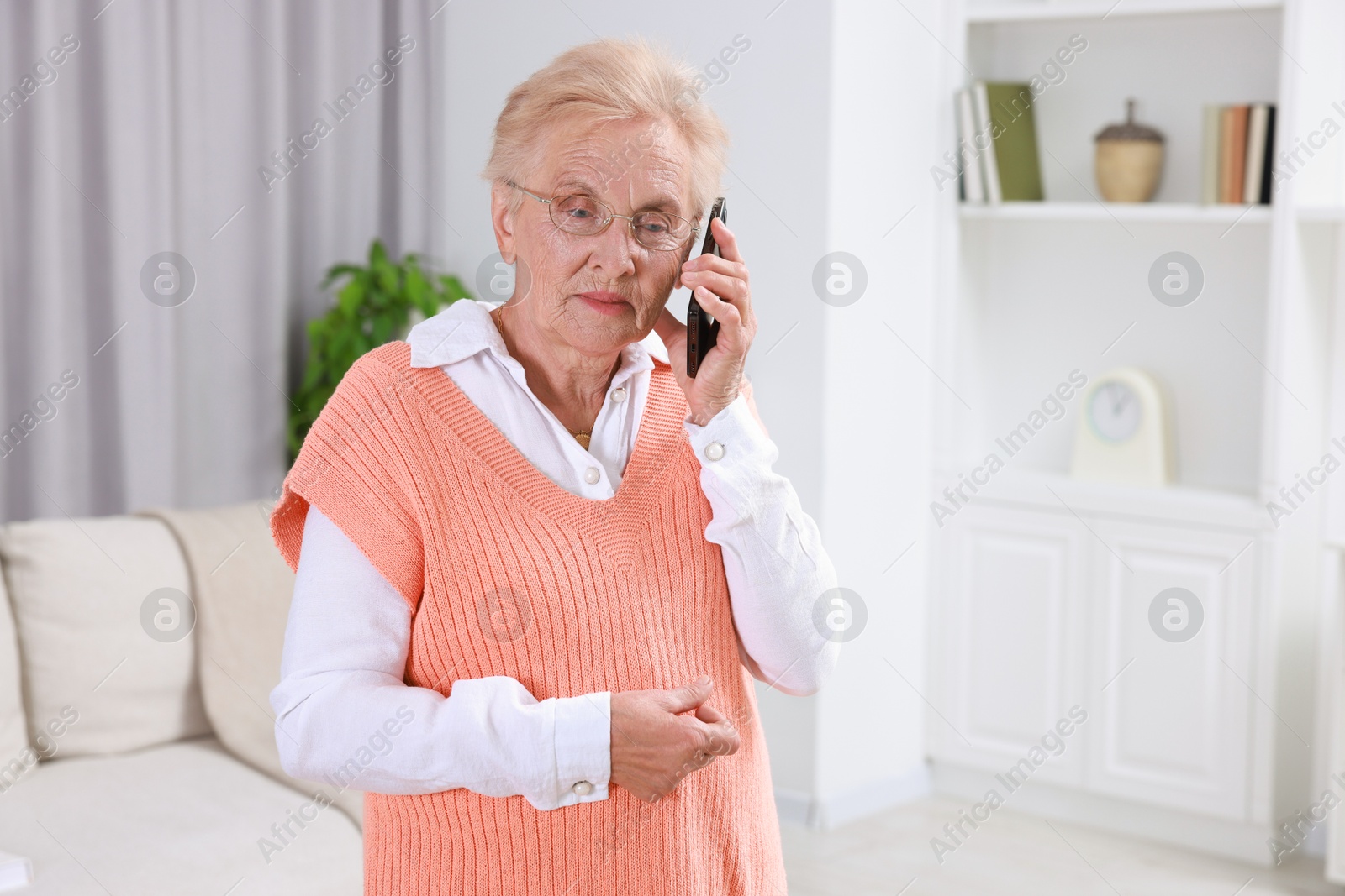 Photo of Senior woman talking on phone at home. Space for text