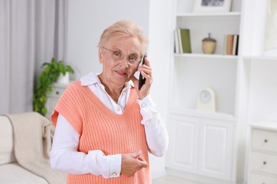 Photo of Senior woman talking on phone at home. Space for text