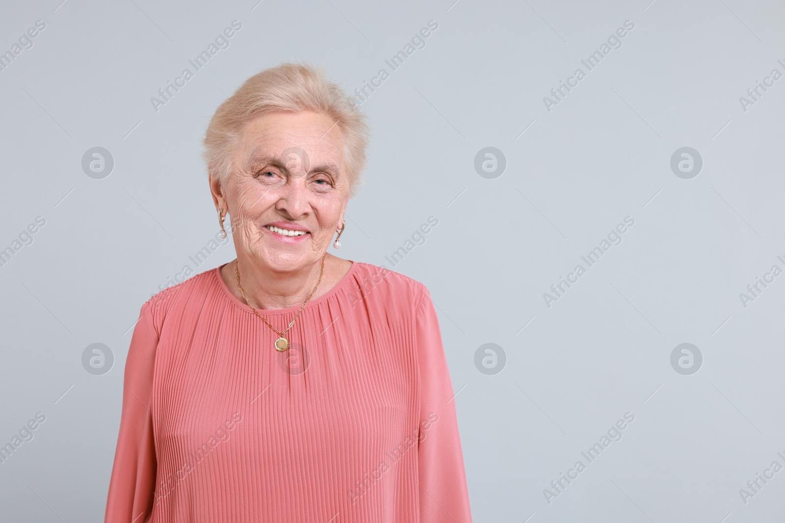 Photo of Portrait of senior woman on light background. Space for text