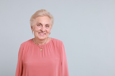 Photo of Portrait of senior woman on light background. Space for text