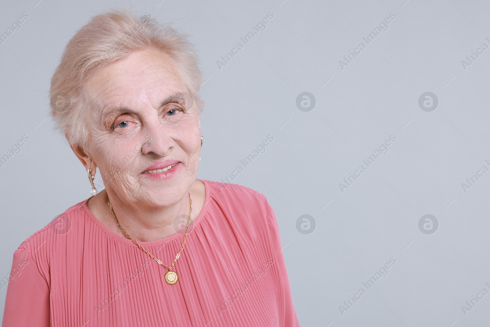 Photo of Portrait of senior woman on light background. Space for text