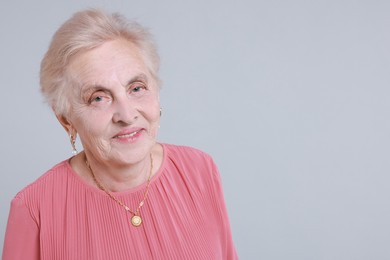 Photo of Portrait of senior woman on light background. Space for text