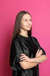 Photo of Teenage girl with stylish hair clips on pink background