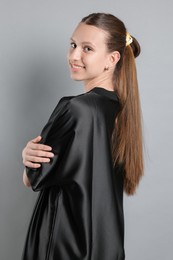 Photo of Teenage girl with stylish bandana on light grey background