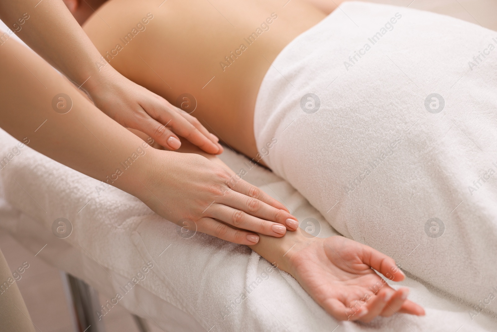 Photo of Woman receiving massage in spa salon, closeup