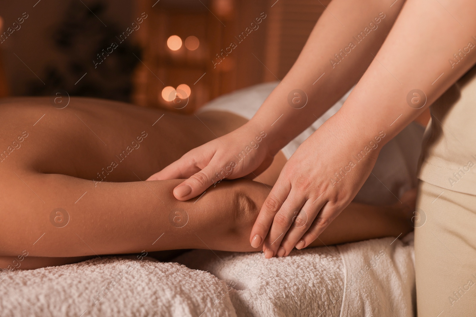 Photo of Woman receiving massage in spa salon, closeup