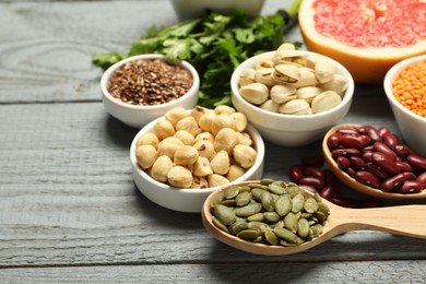 Photo of Superfood. Different healthy food products on grey wooden table, closeup. Space for text