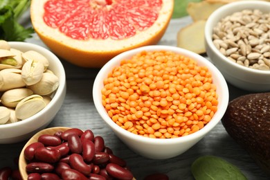 Photo of Superfood. Different healthy food products on grey wooden table, closeup