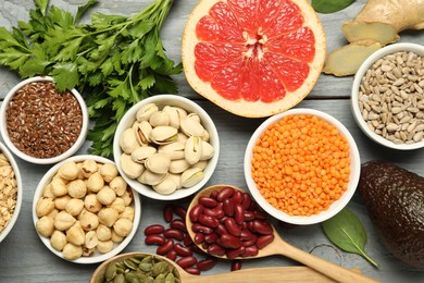 Photo of Superfood. Different healthy food products on grey wooden table, flat lay