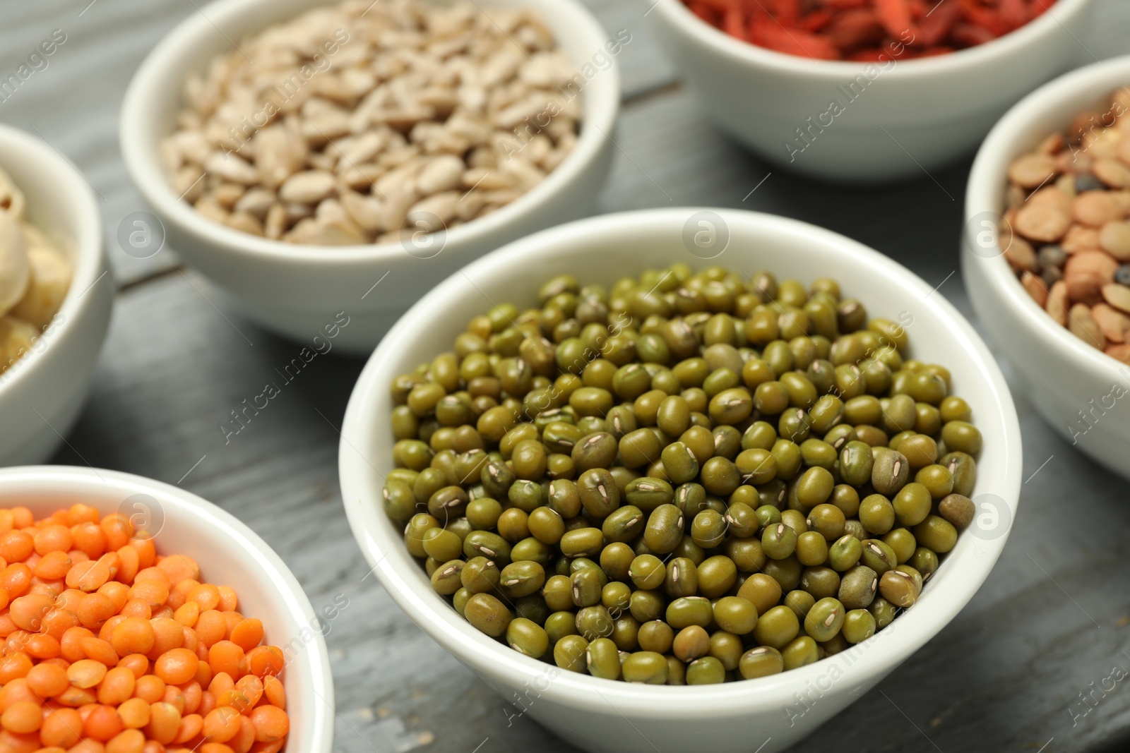 Photo of Superfood. Different healthy food products on grey table, closeup