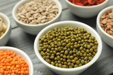 Photo of Superfood. Different healthy food products on grey table, closeup