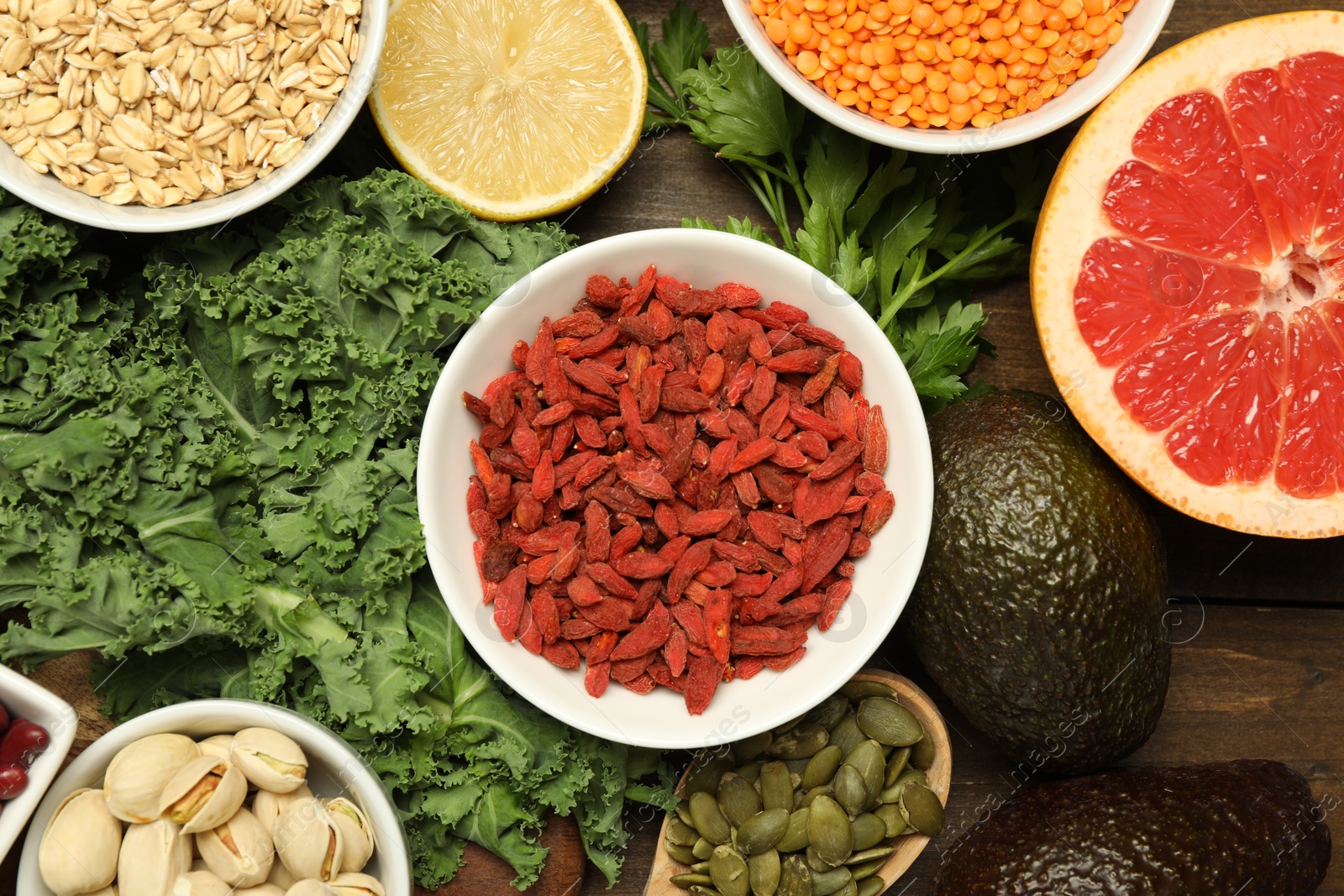 Photo of Superfood. Different healthy food products on wooden table, flat lay