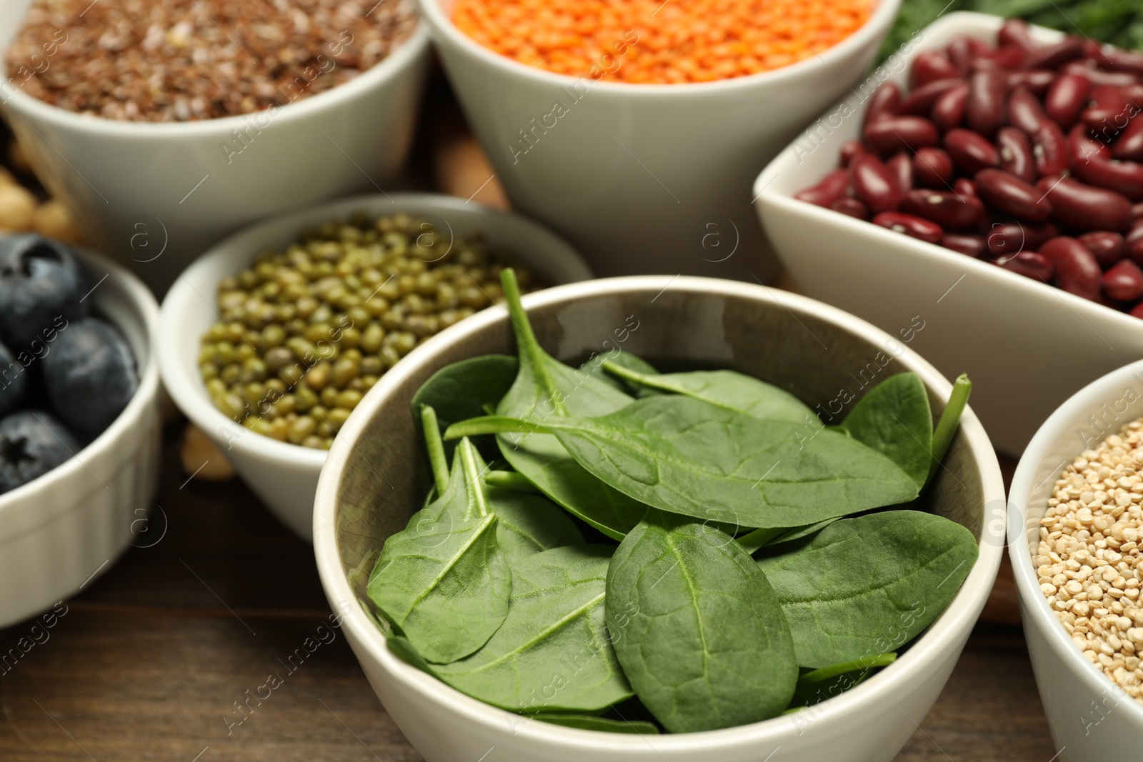 Photo of Superfood. Different healthy food products on wooden table, closeup