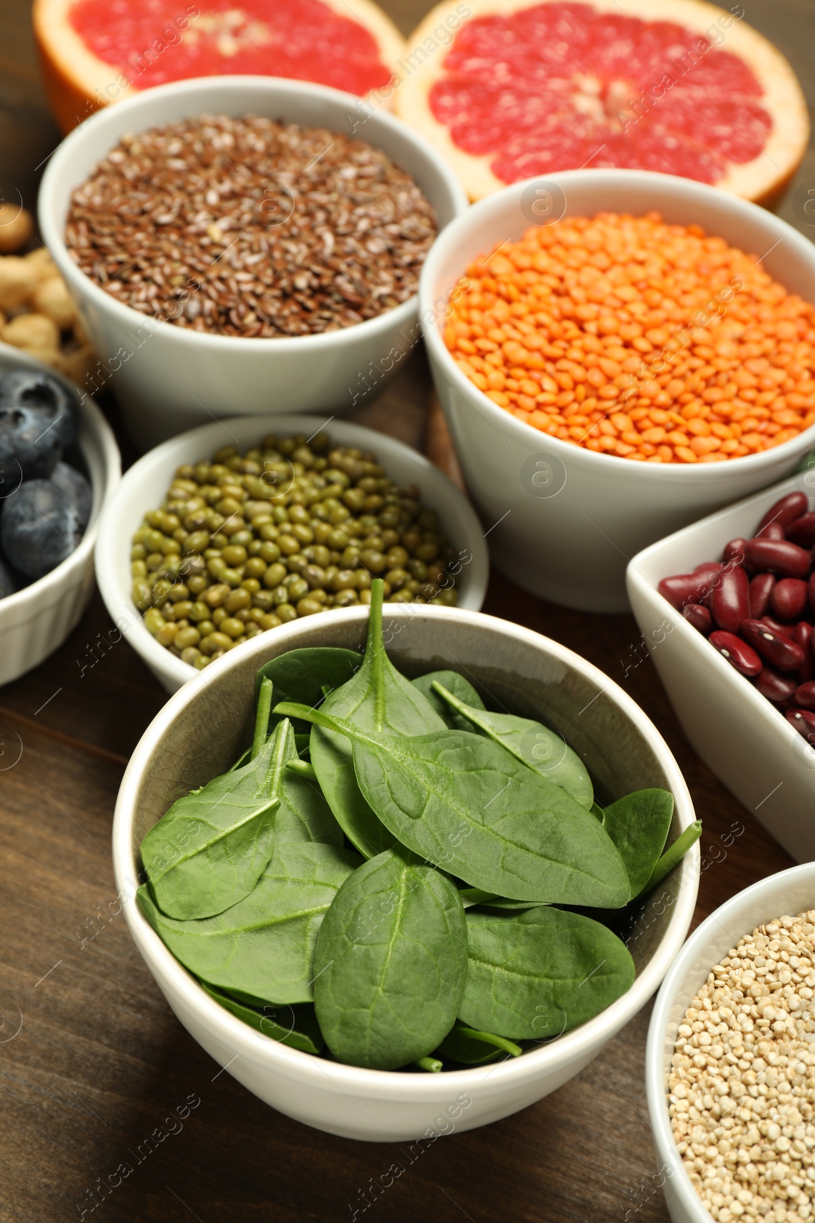 Photo of Superfood. Different healthy food products on wooden table, closeup