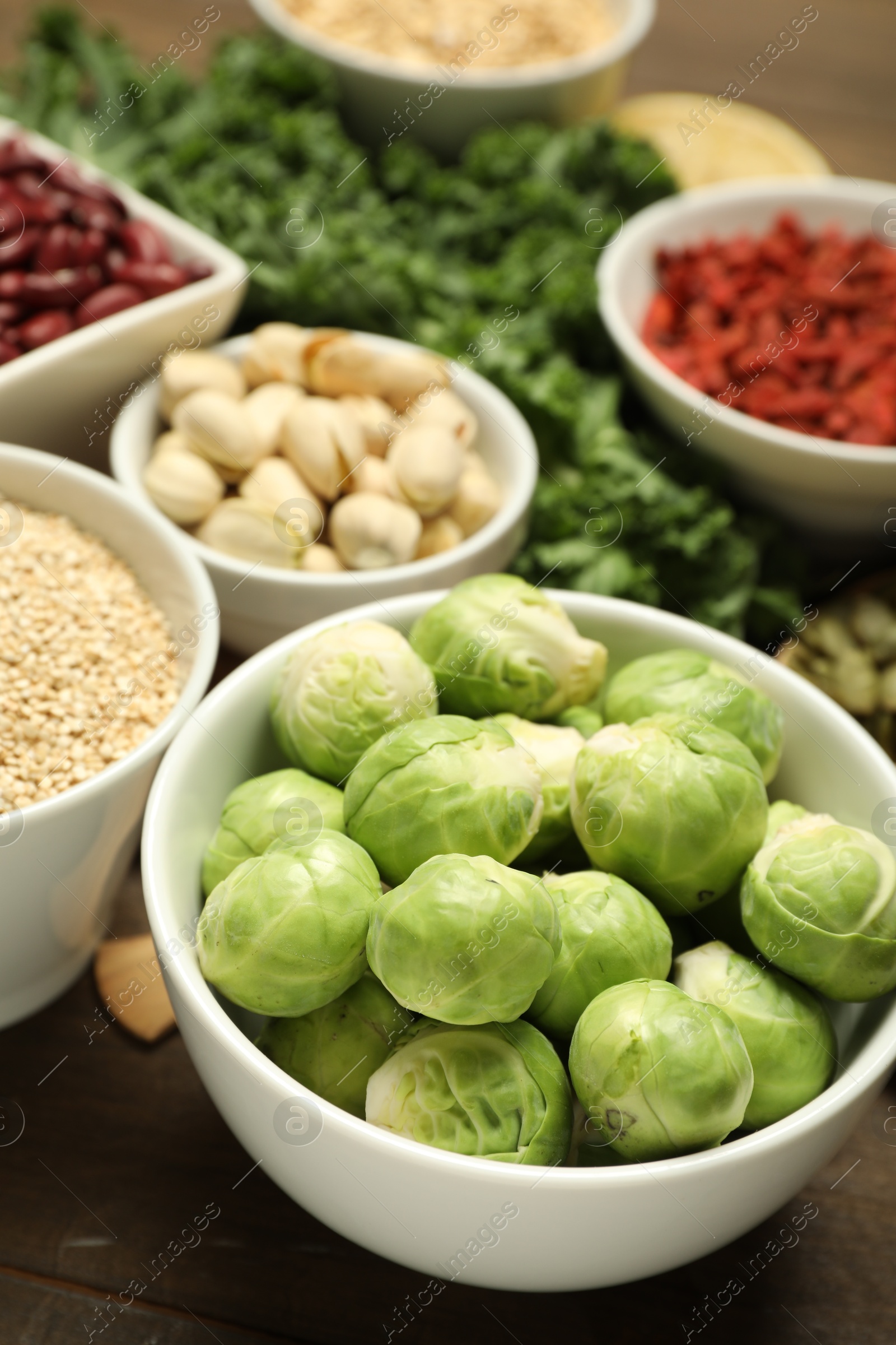 Photo of Superfood. Different healthy food products on wooden table, closeup