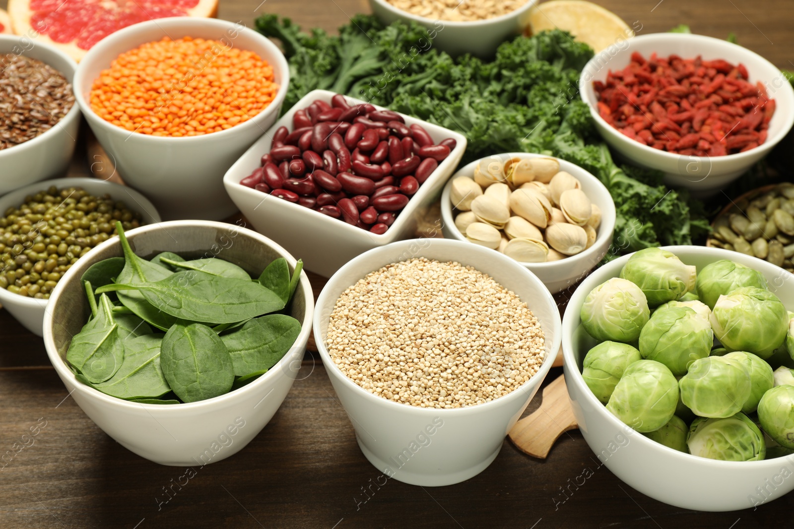 Photo of Superfood. Different healthy food products on wooden table, closeup