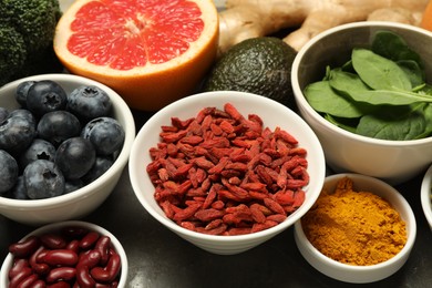 Photo of Superfood. Different healthy food products on grey table, closeup