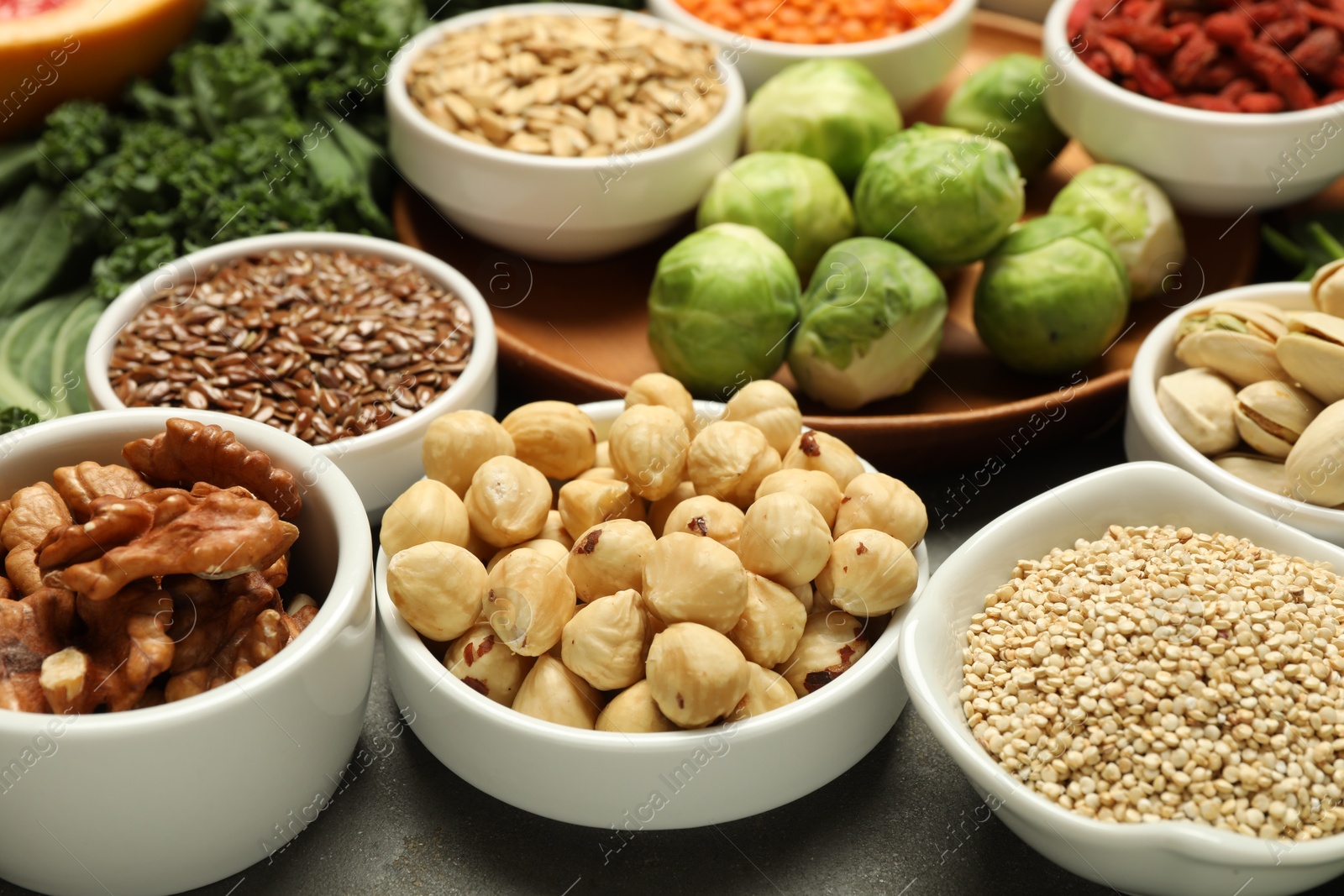 Photo of Superfood. Different healthy food products on grey table, closeup