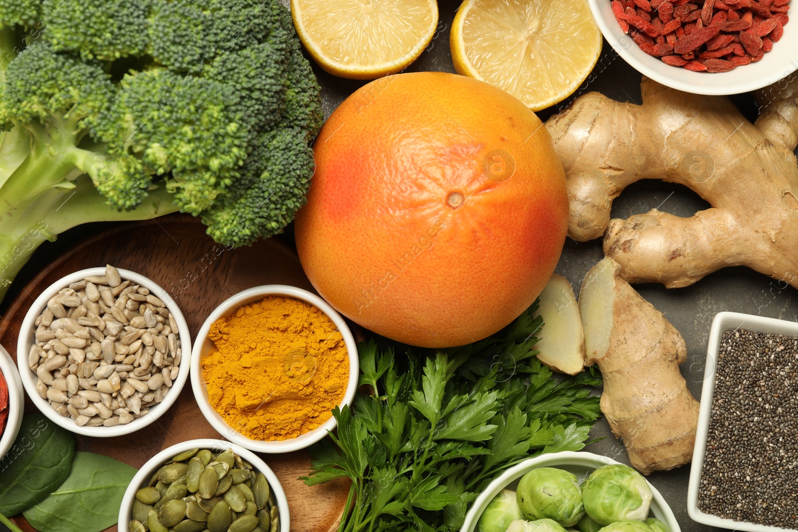 Photo of Superfood. Different healthy food products on grey table, flat lay