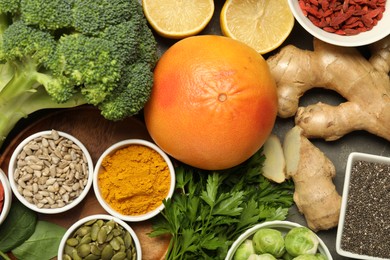 Photo of Superfood. Different healthy food products on grey table, flat lay