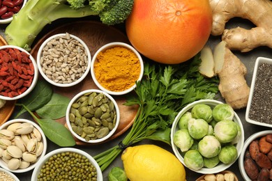 Photo of Superfood. Different healthy food products on grey table, flat lay