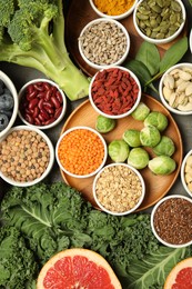 Photo of Superfood. Different healthy food products on grey table, flat lay