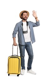 Photo of Happy tourist in hat with suitcase and camera on white background