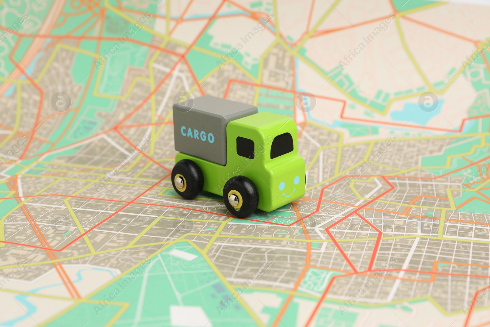 Photo of Toy truck on city map. Logistics concept