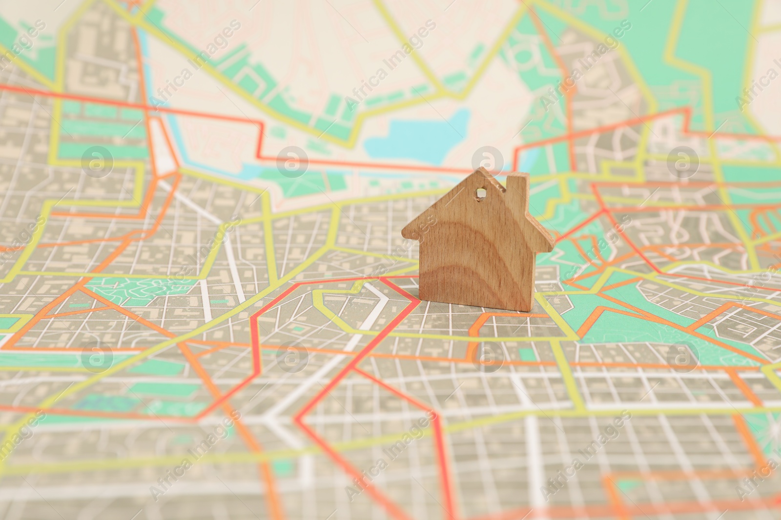 Photo of Wooden house model on city map. Accommodation search