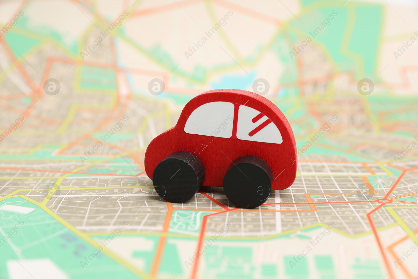 Photo of Red toy car on city map. Road trip