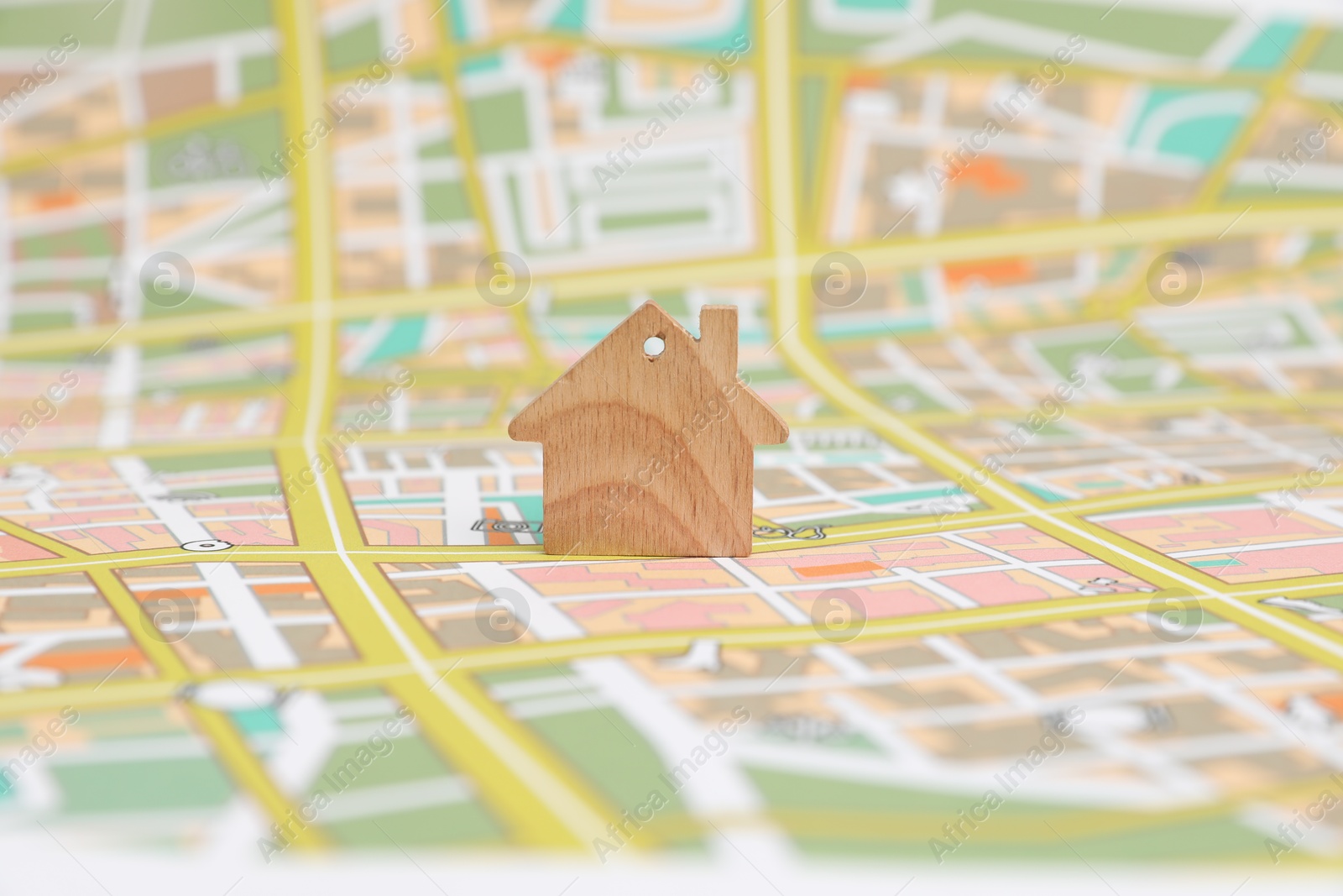 Photo of One wooden house model on city map. Accommodation search