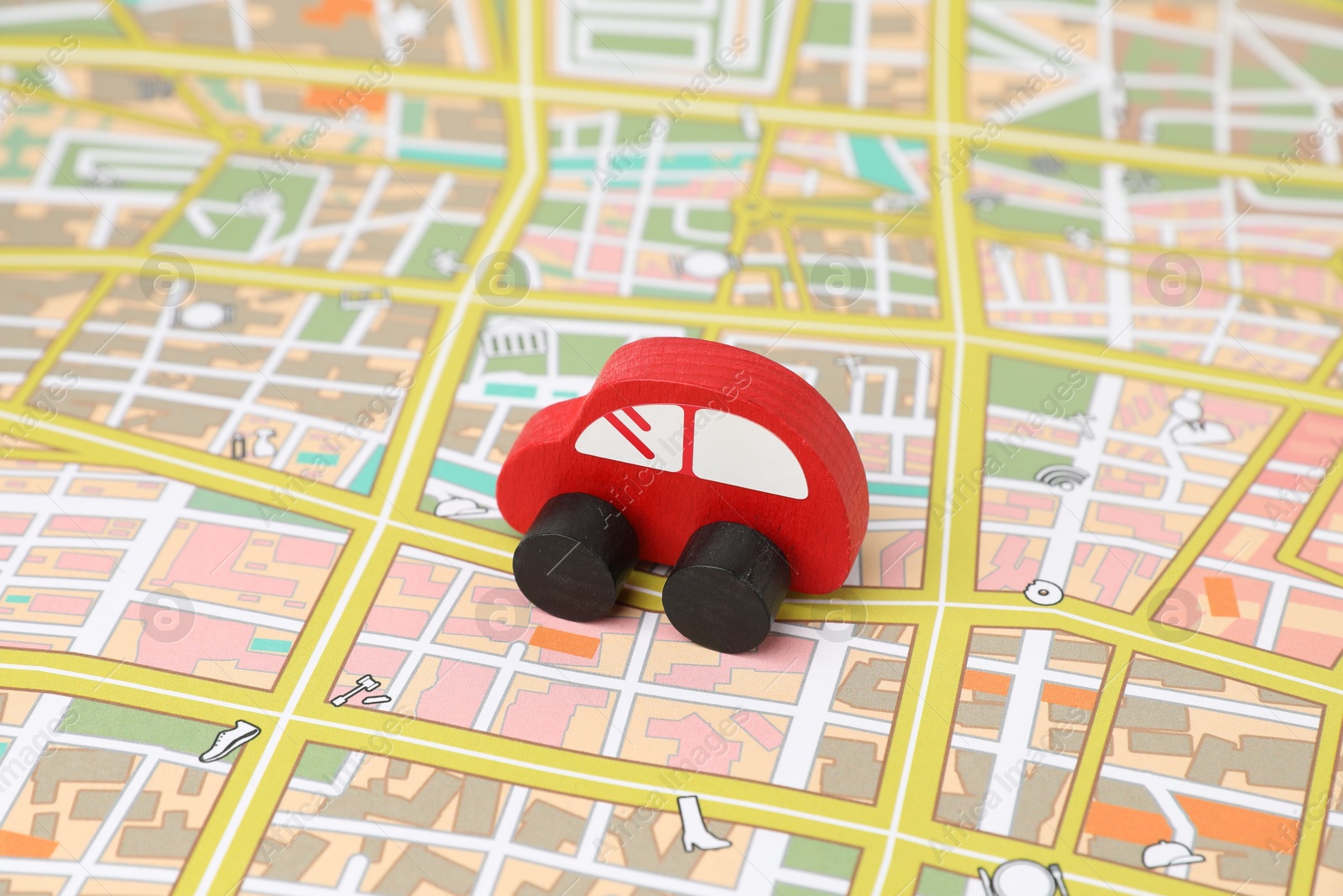 Photo of Red toy car on city map. Road trip