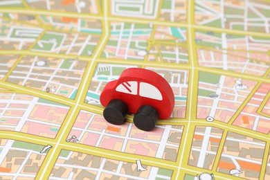 Photo of Red toy car on city map. Road trip