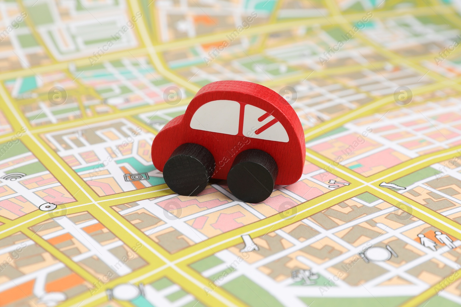 Photo of Red toy car on city map. Road trip