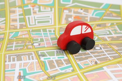 Photo of Red toy car on city map. Road trip