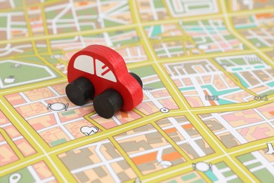 Photo of Red toy car on city map. Road trip