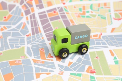 Photo of Toy truck on city map. Logistics concept