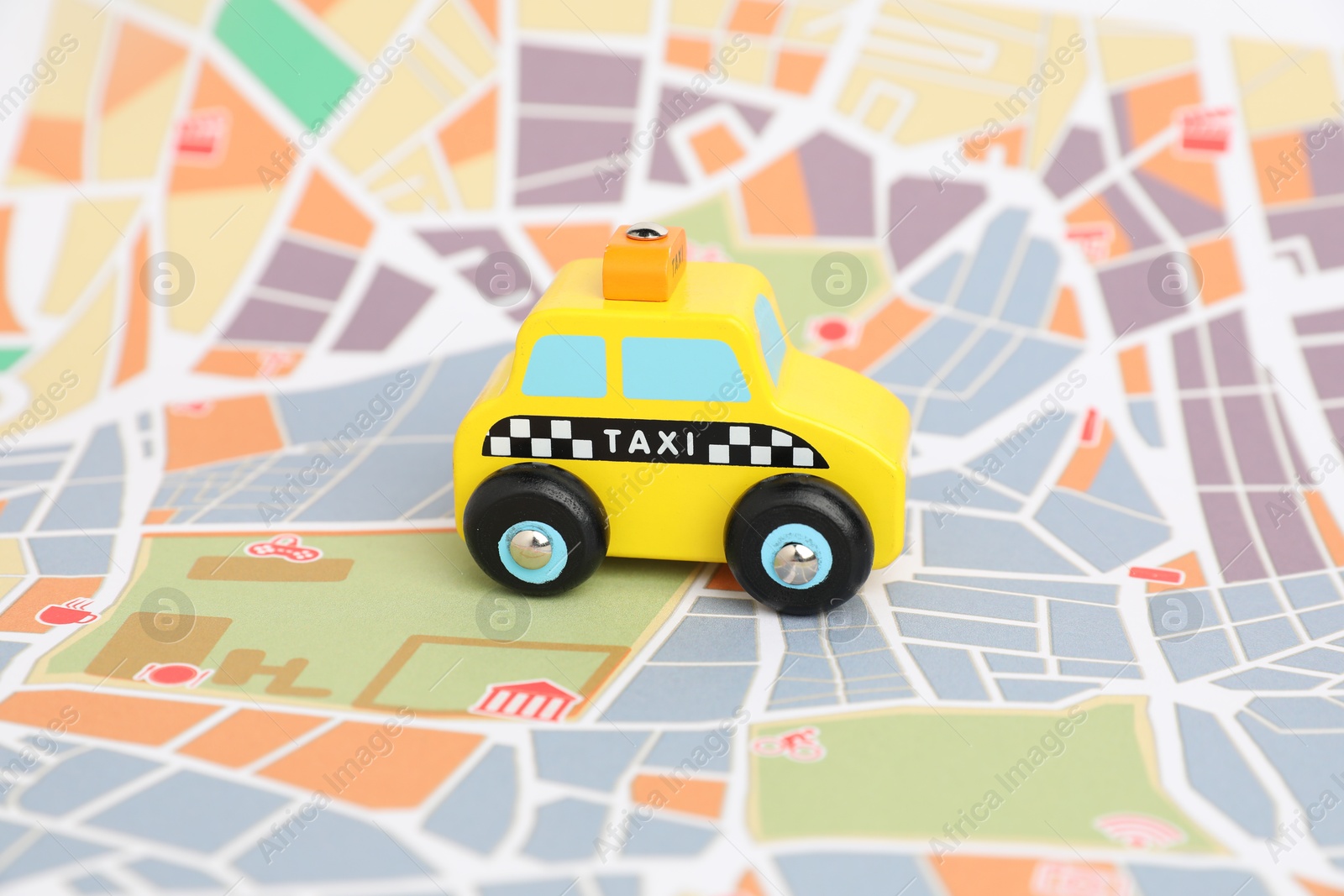 Photo of Yellow taxi car on city map. Road trip