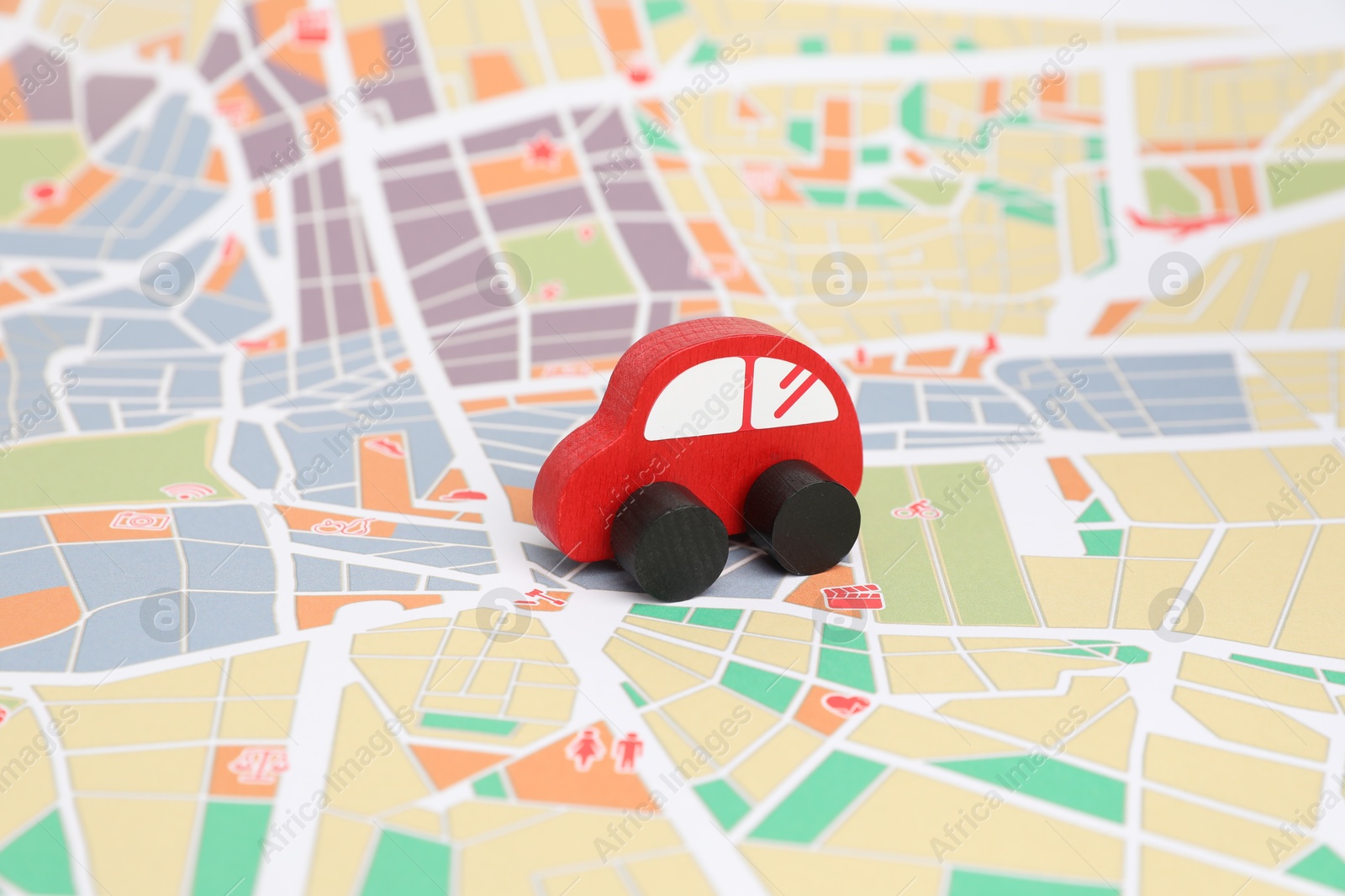 Photo of Red toy car on city map. Road trip