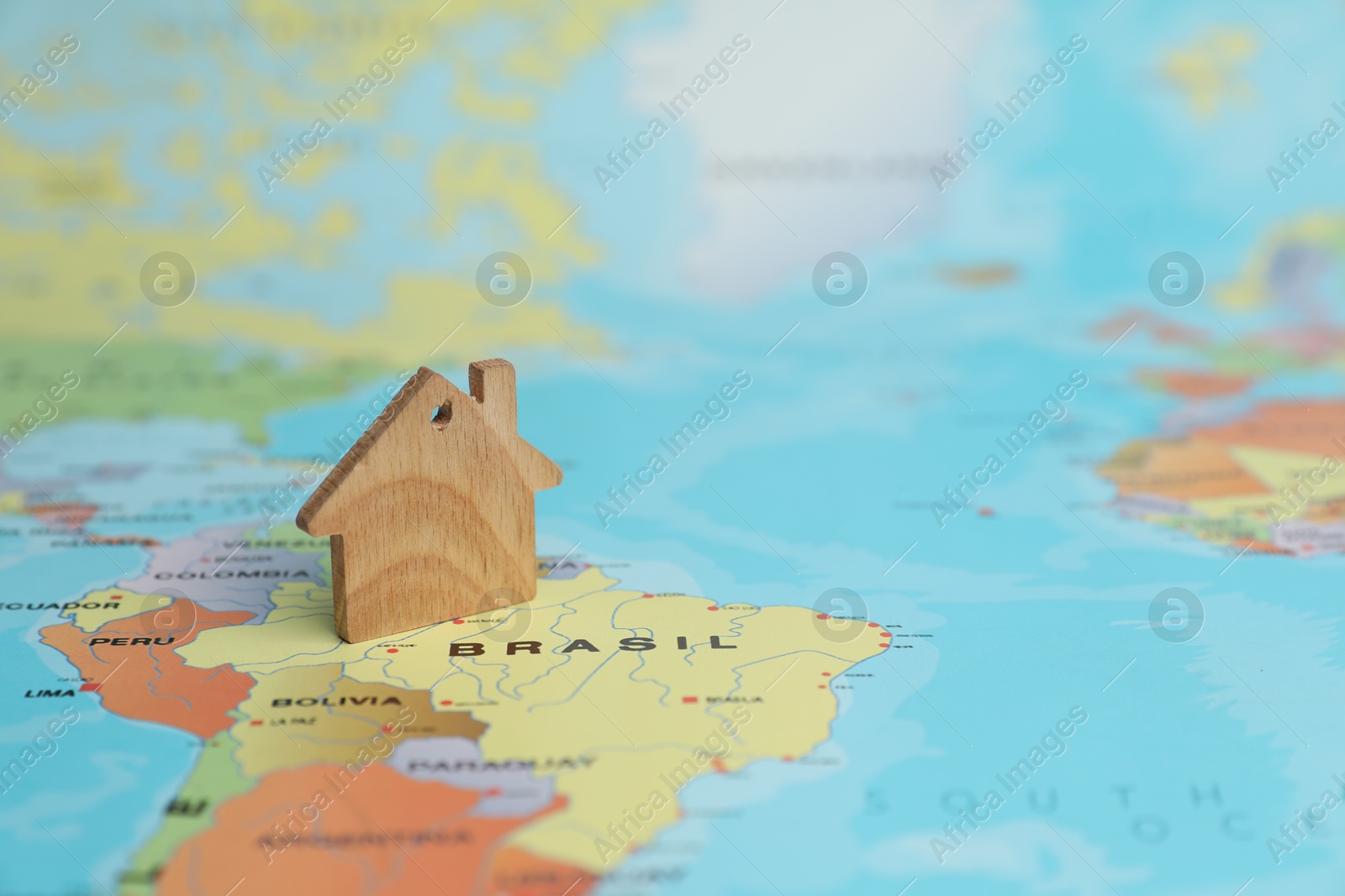 Photo of Wooden house model on world map. Accommodation search