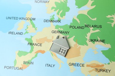 Photo of Metal house model on world map, above view. Accommodation search