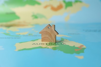 Photo of One wooden house model on world map. Accommodation search