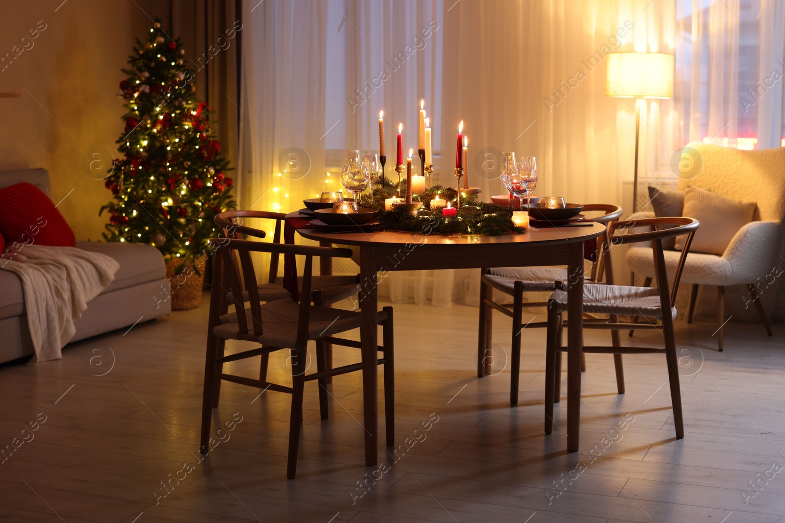 Photo of Festive table setting in room decorated for Christmas. Bokeh effect