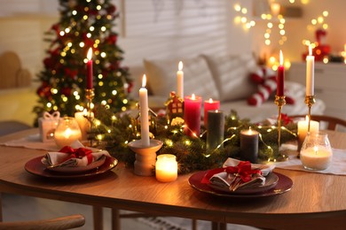 Photo of Festive table setting in room decorated for Christmas. Bokeh effect