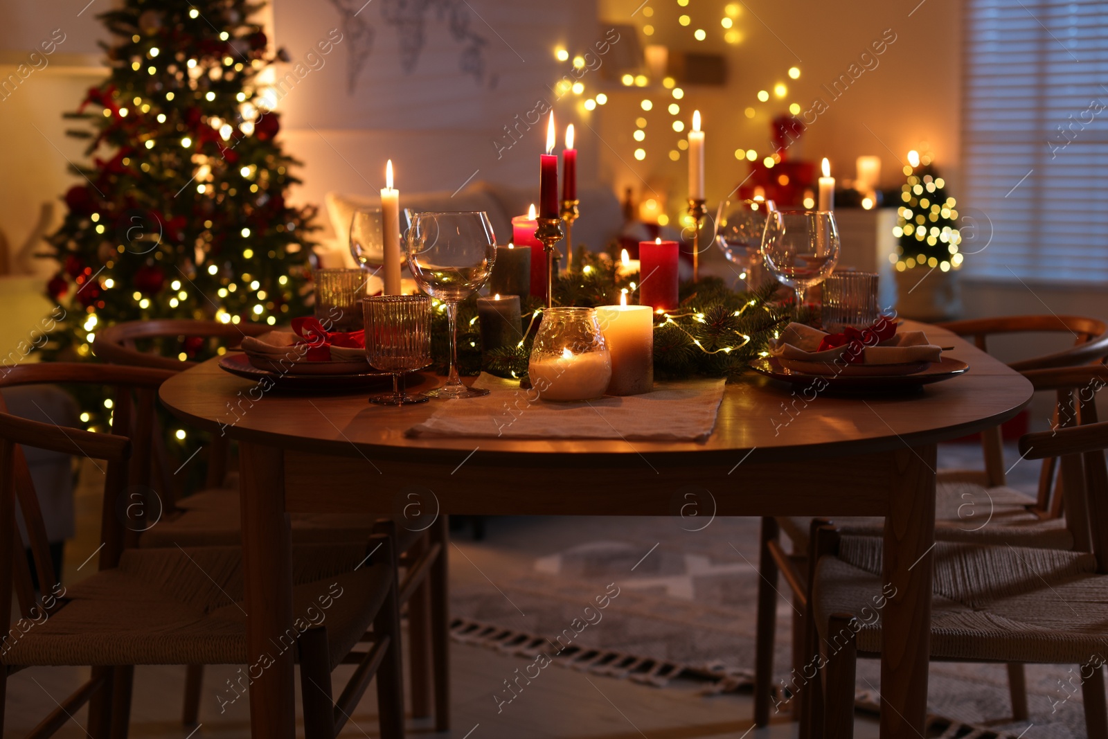 Photo of Festive table setting in room decorated for Christmas. Bokeh effect