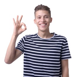 Photo of Happy young man showing OK gesture on white background